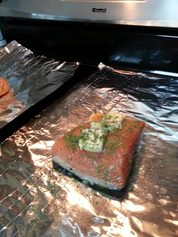 Lemon on the bottom, salmon, tarragon, butter, salt, pepper and lemon juice ready to go on the grill.