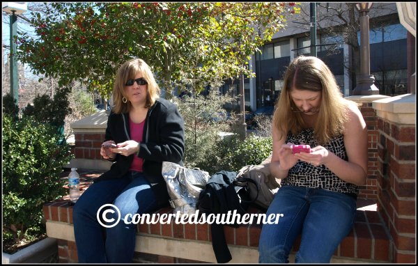 Rach and Gail playing on their phones while we wait for our table at Tupelo Honey in Asheville 